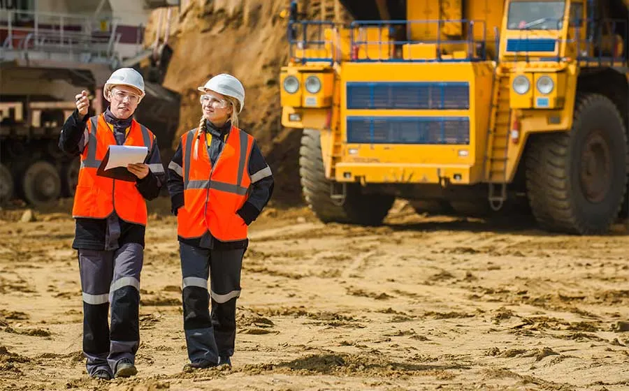 Mining workers and heavy machinery